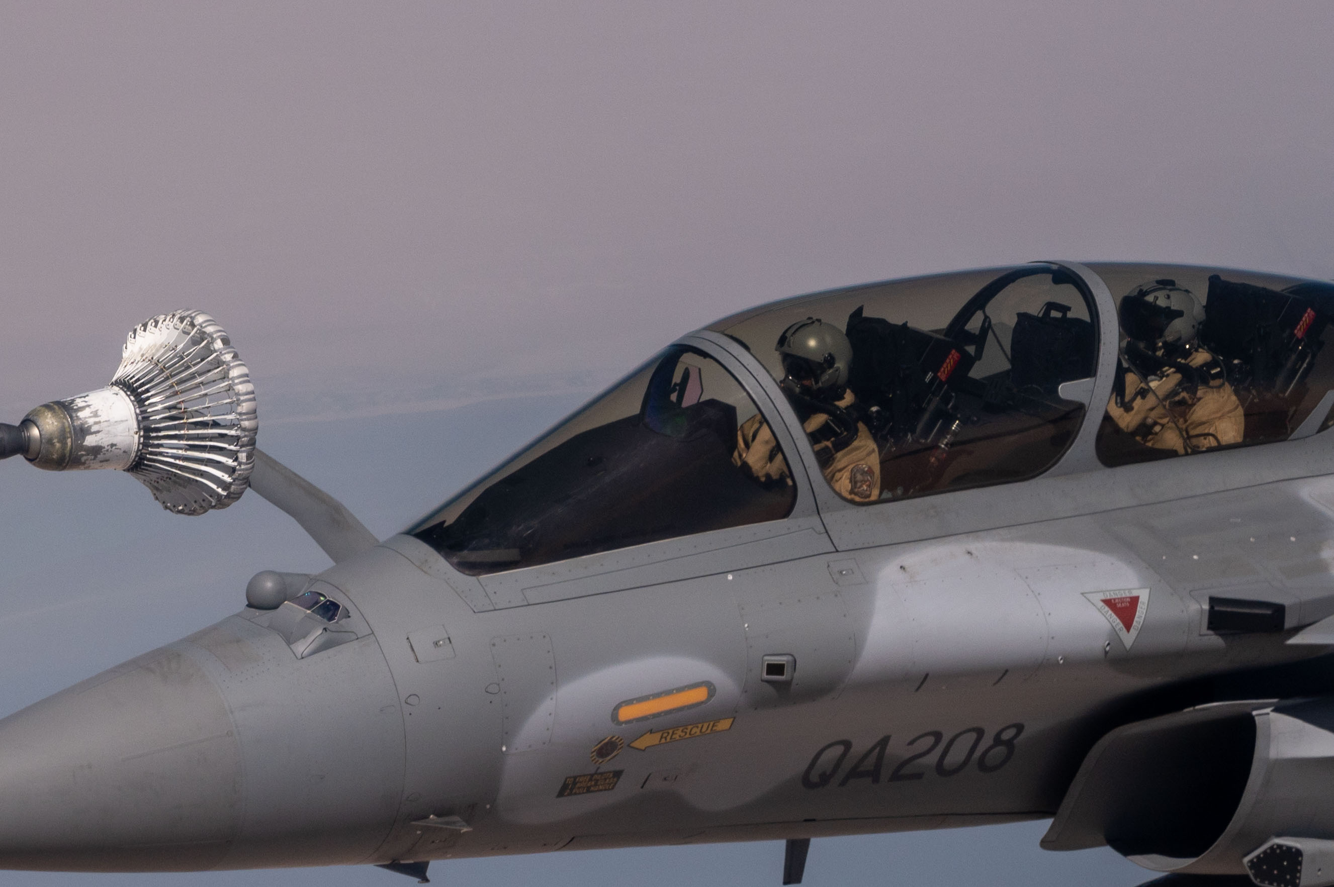 Image shows a close up of Pilots in the Qatari fast jet, during air-to-air refuelling.